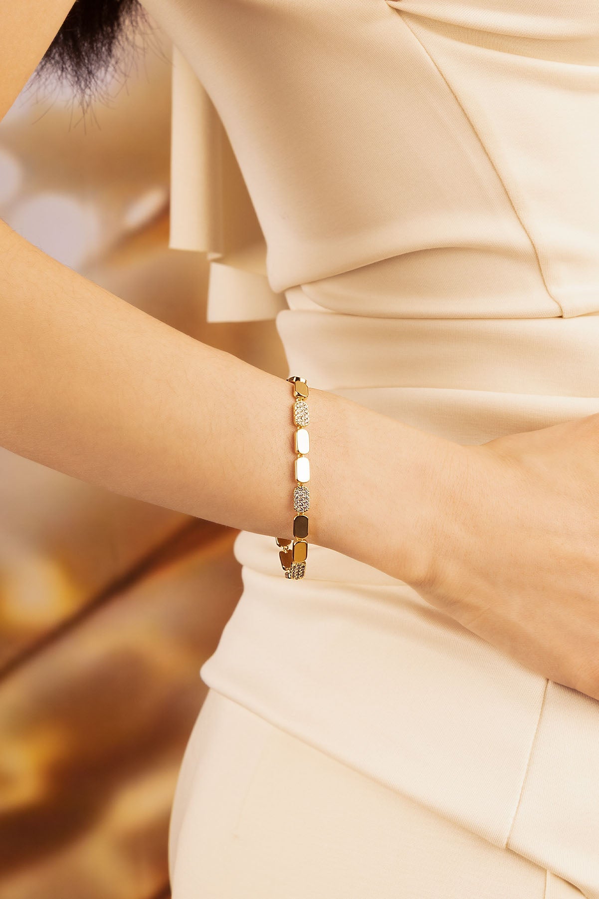 APM Monaco Dainty Gold Bracelet in Yellow Gold worn on hand