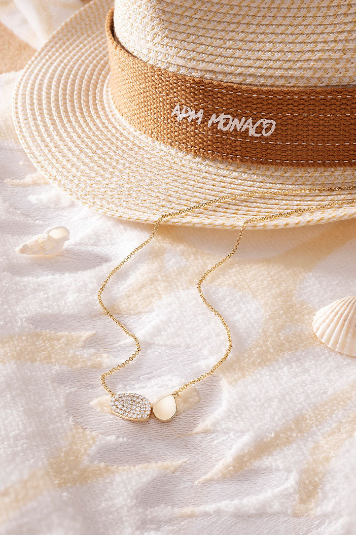 APM Monaco Galet Adjustable Necklace in yellow gold on soft blanket