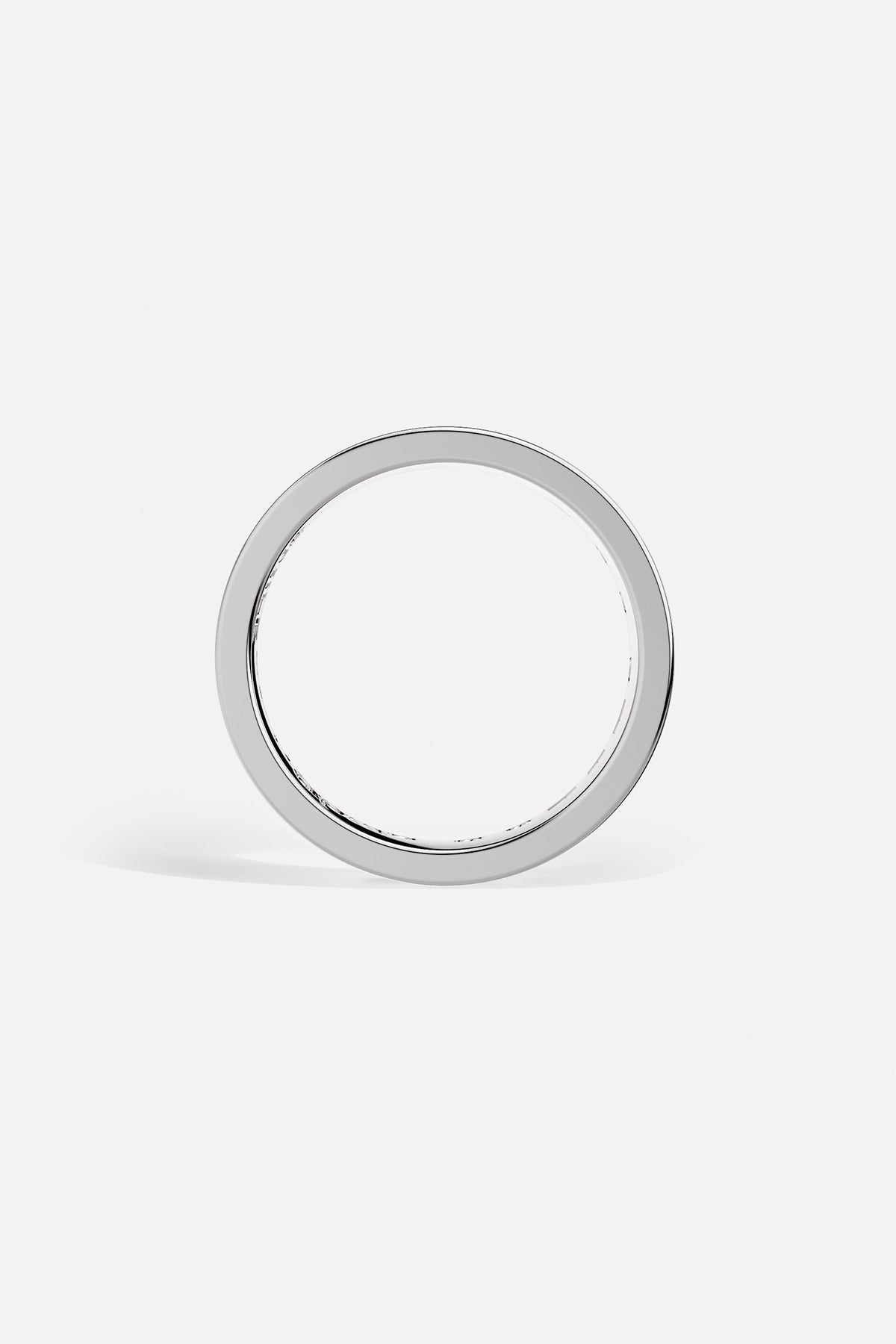 Silver ring with pink gemstones on a white background