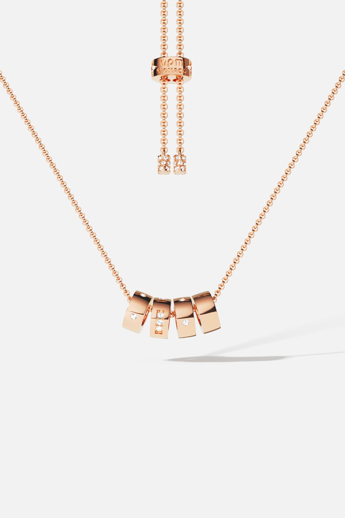 APM Necklace in rose color, sliding charms and quiet sparkle, effortlessly modern.