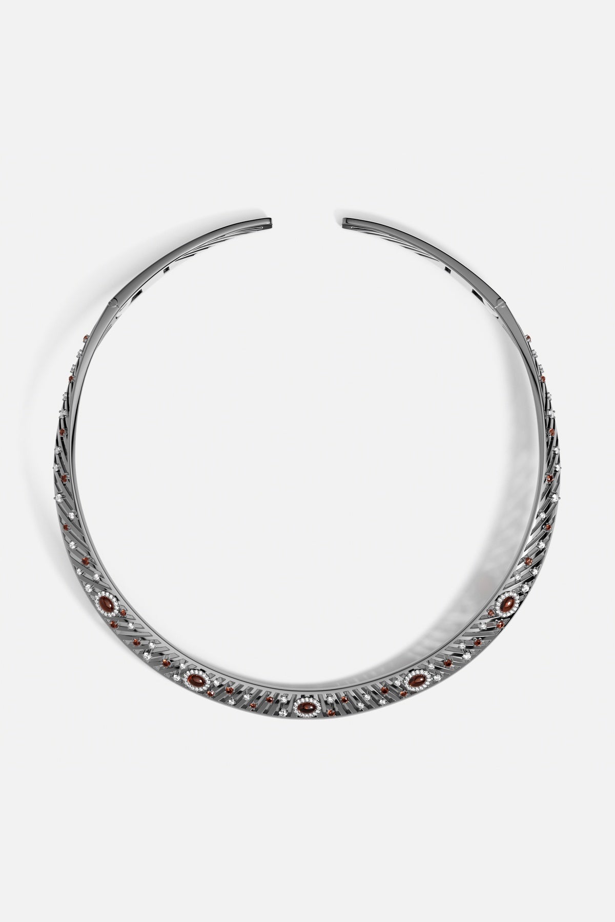 APM torque necklace in rhodium finish, glowing with warm colors and quiet radiance.