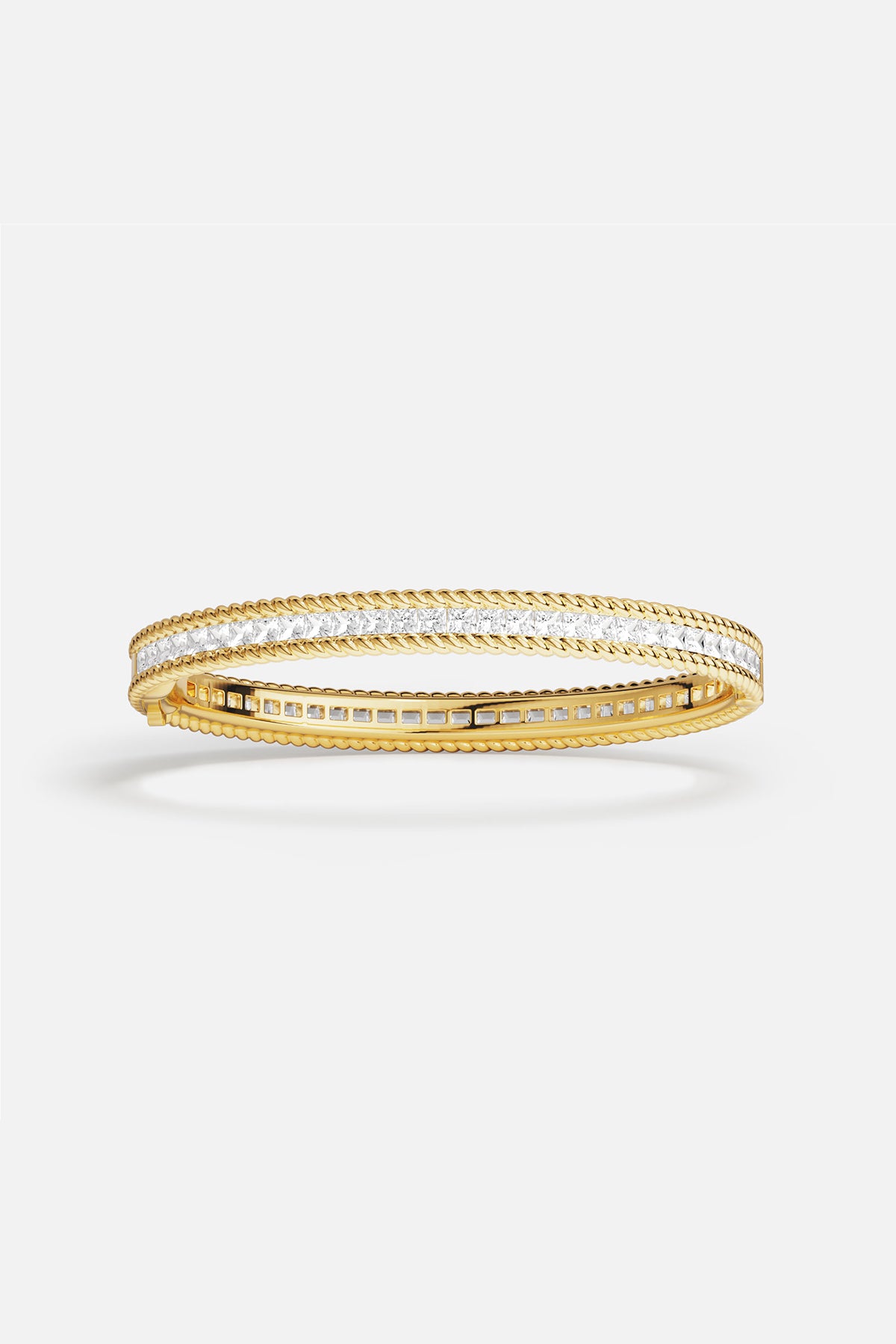 APM Bangle in golden color, twisted edges and crystal shimmer, effortlessly refined.
