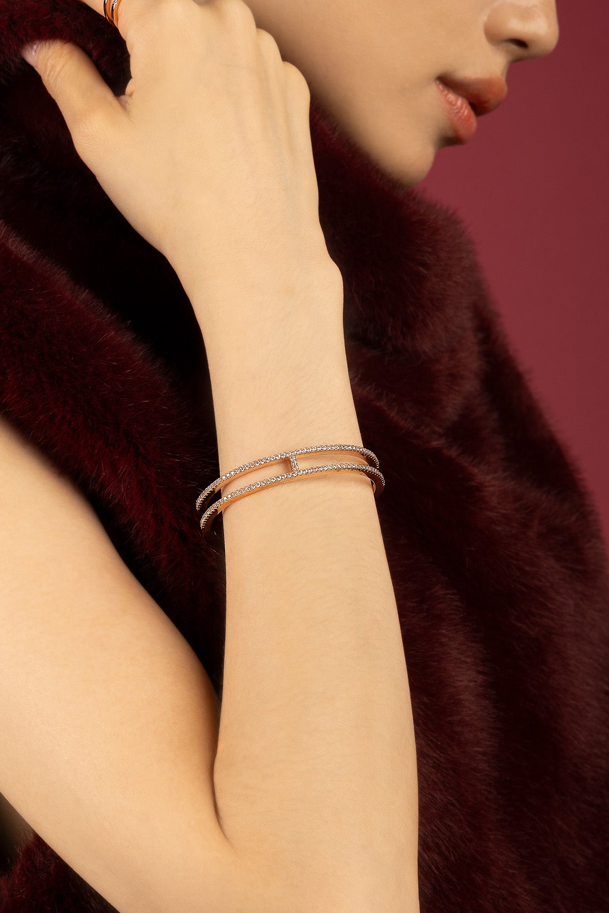 Woman wearing APM double-row bangle, a shimmering whisper of modern elegance.