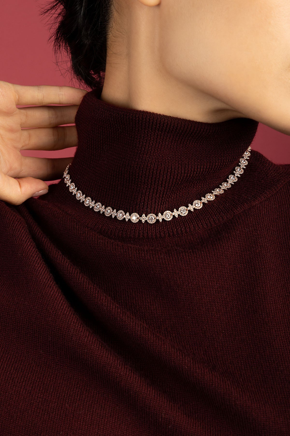 Woman wearing APM Necklace, a shimmering line of quiet winter elegance.