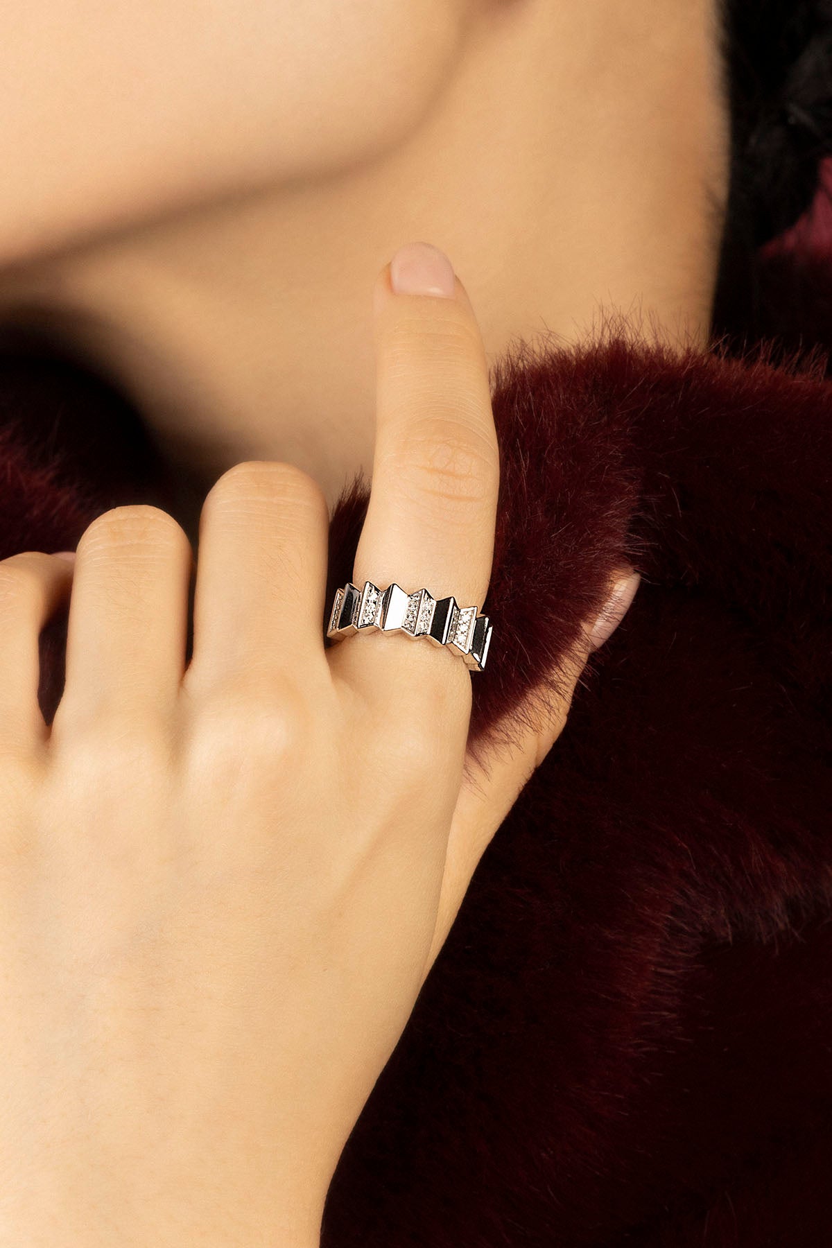 Woman wearing APM Morse Ring, a geometric rhythm of rhodium finish and sparkle.