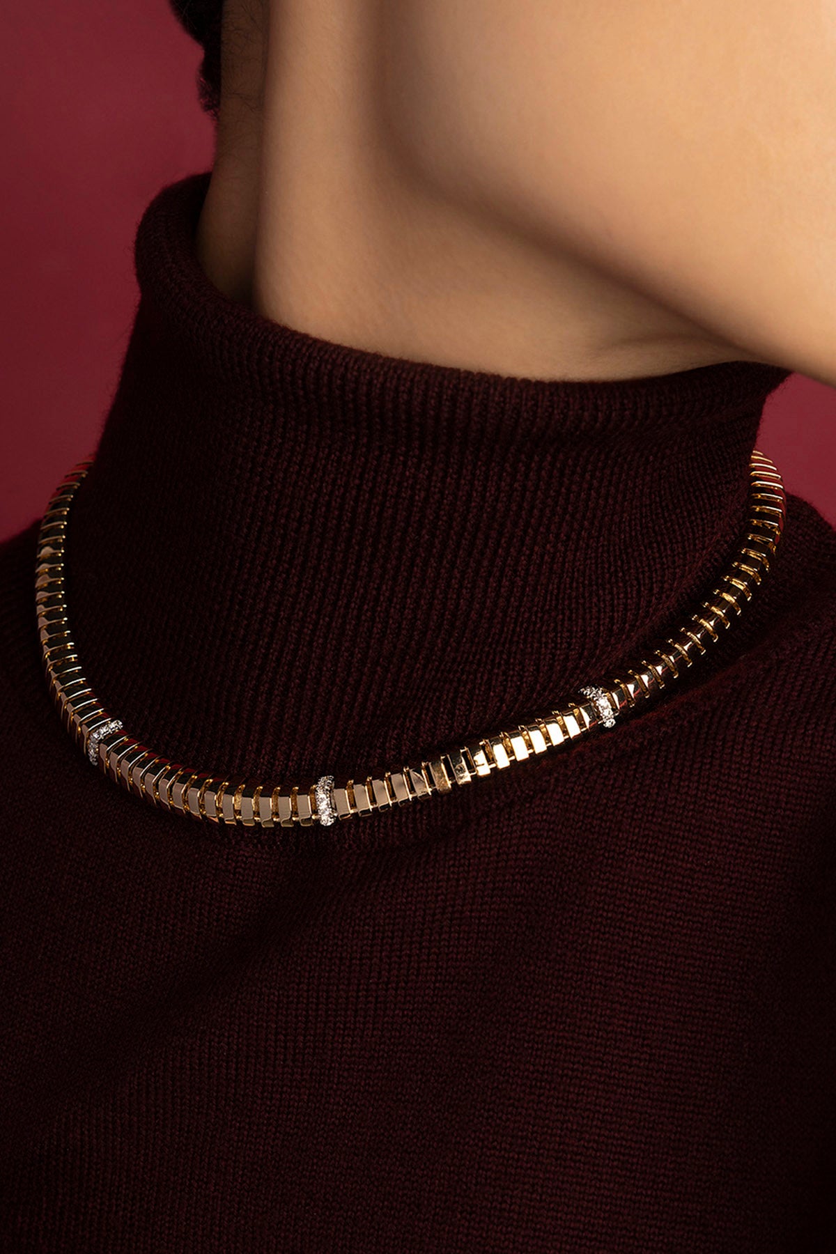 Woman wearing APM necklace, a golden whisper of modern elegance.