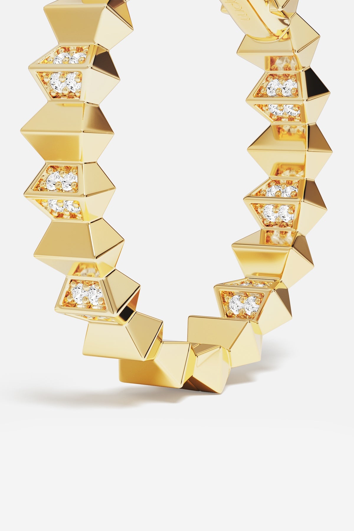 APM Bracelet in gold color, faceted edges and sparkling accents, bold modern allure.