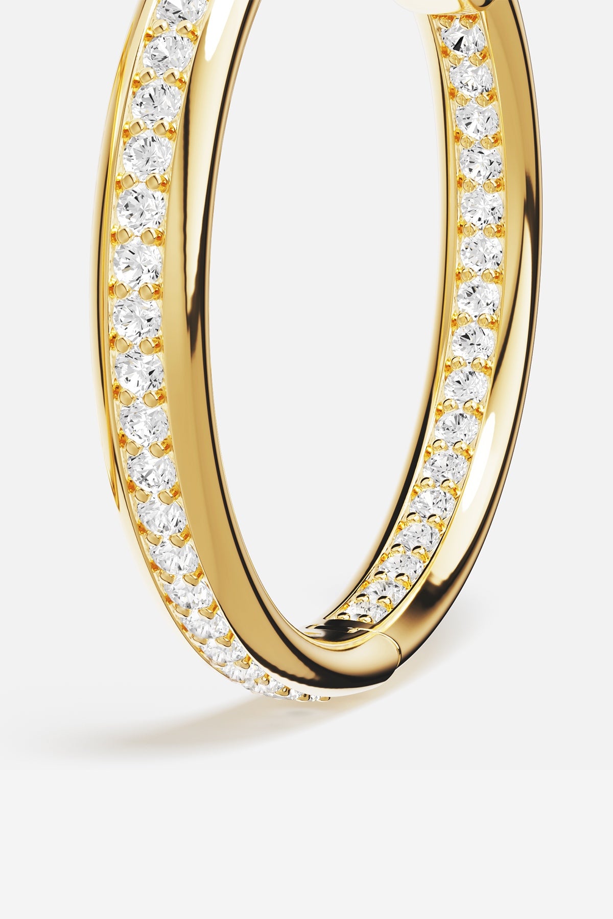 APM Hoop Earrings in golden color, a radiant sparkle for effortless allure.