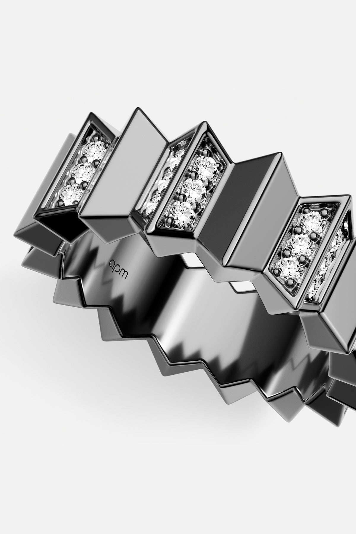 APM Ring in dark rhodium finish, sculpted zigzag edge with a modern architectural pulse.