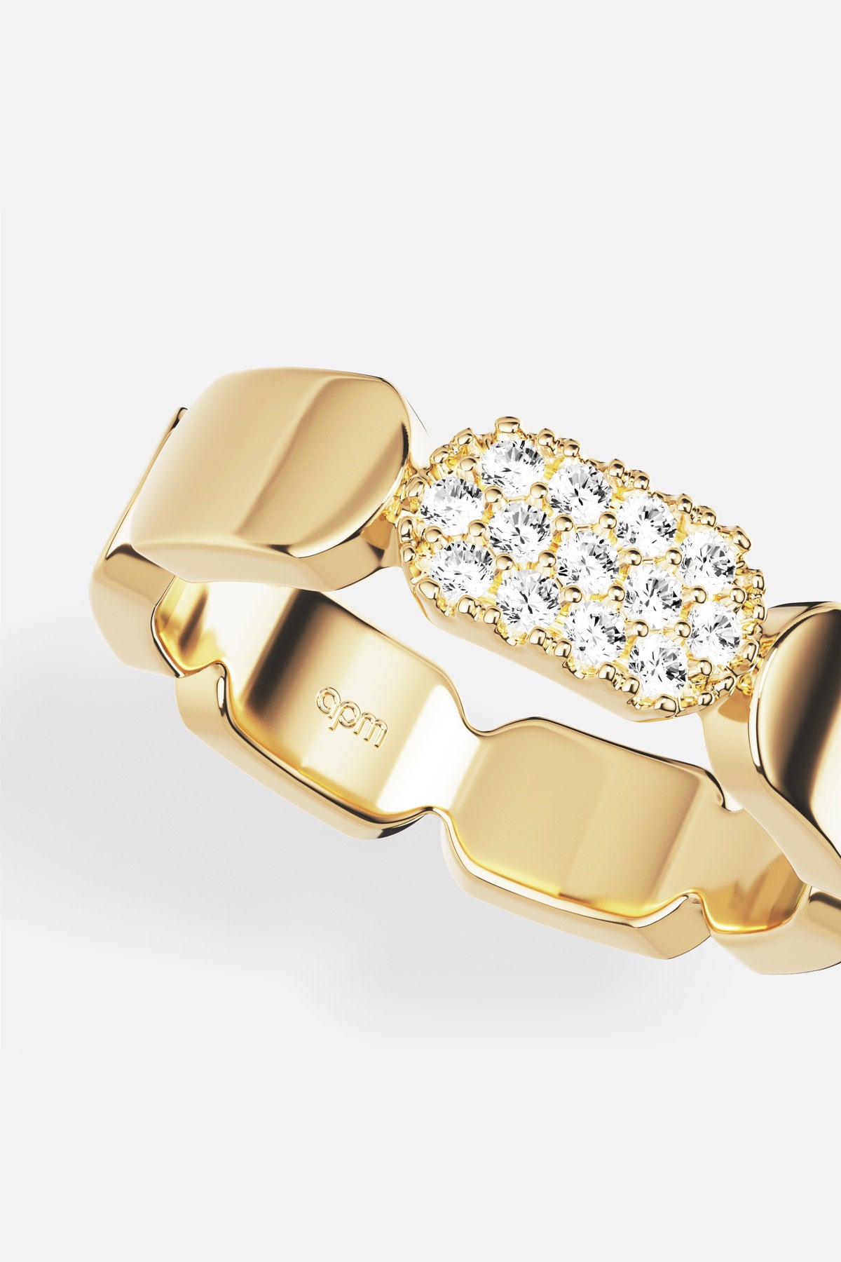 APM Ring in golden color, sculpted links meeting a shimmering pavé glow.