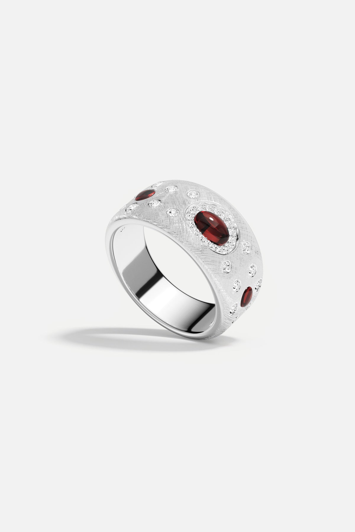 APM Ring in rhodium finish, glowing with deep red accents, quietly bold.