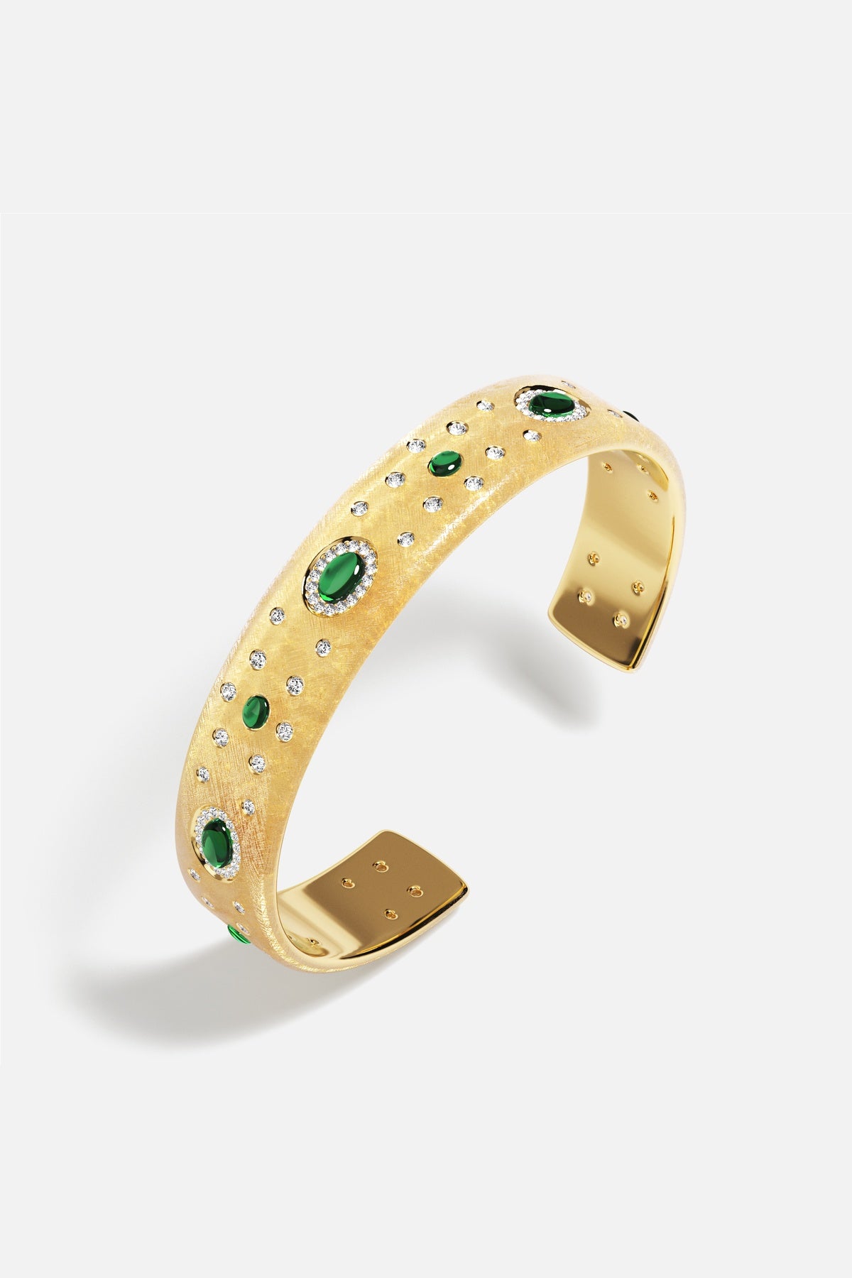 APM Cuff Bracelet in golden hues, scattered with emerald green stones, radiant elegance.