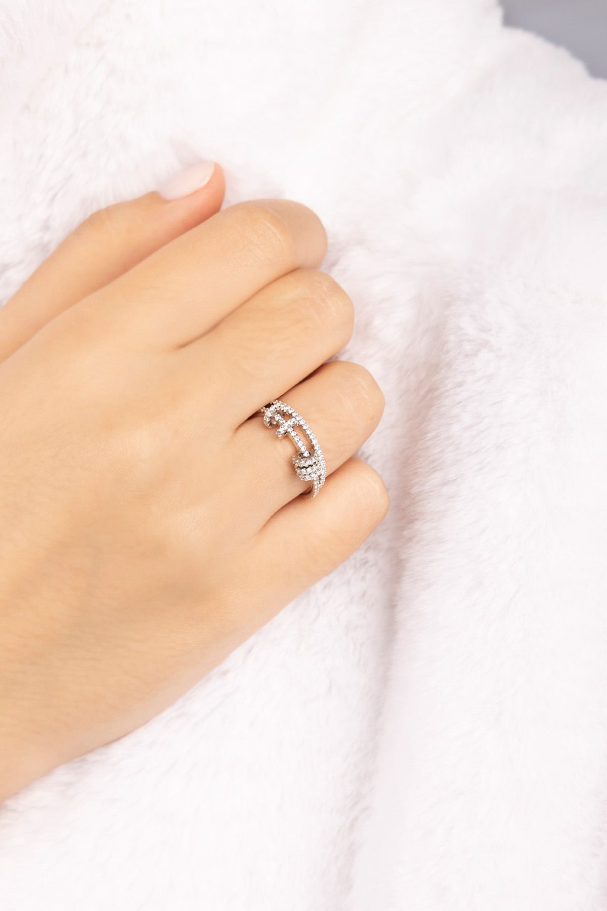 APM MONACO croisette ring in silver on a hand with a white background