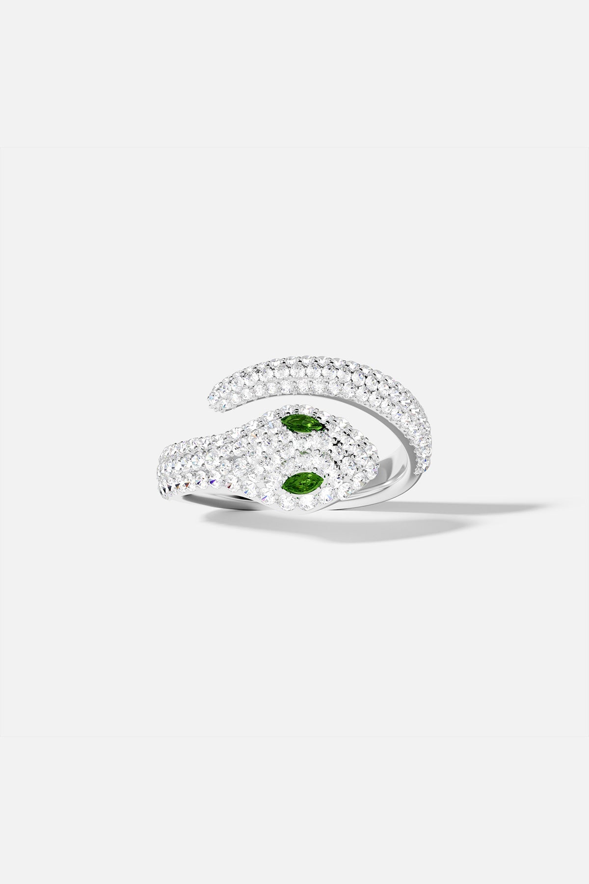 Rings APM Monaco serpentine wrap ring in white metal with pavé diamonds and two green eyes.