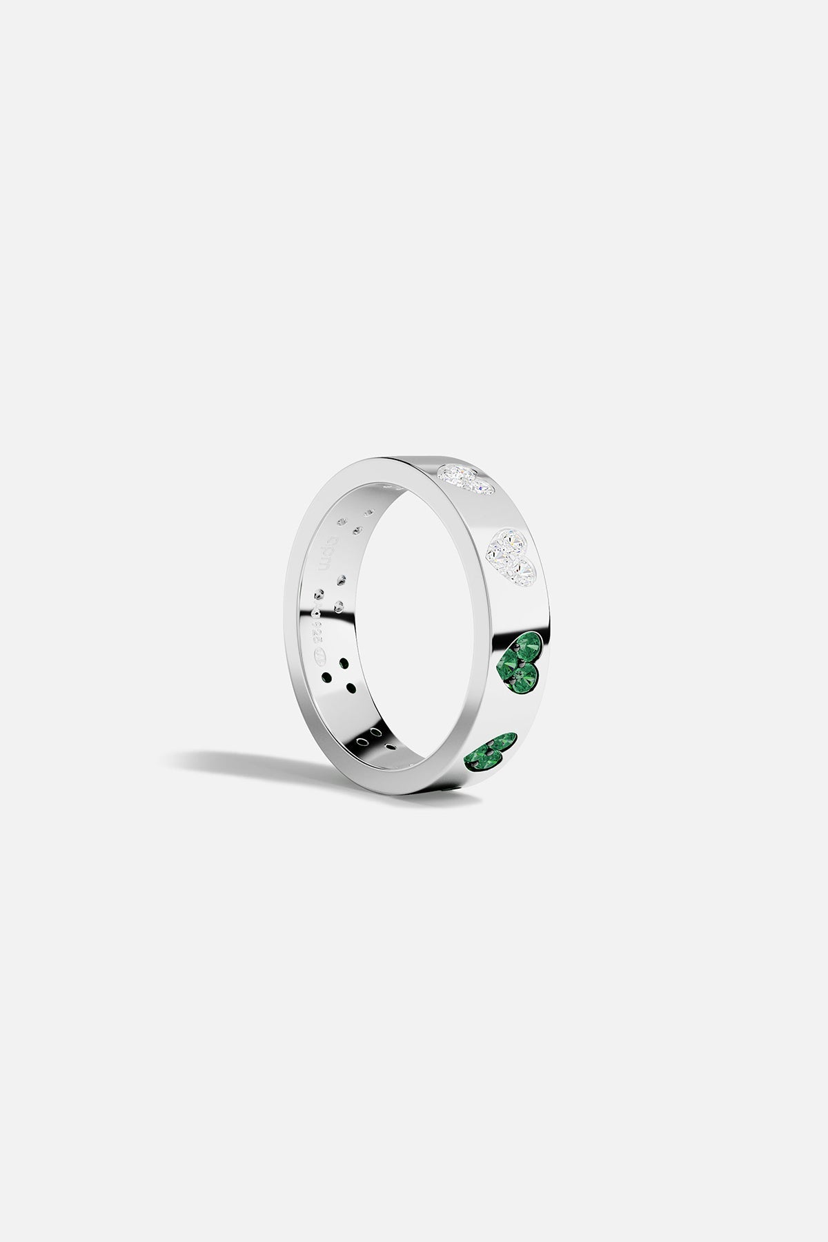 Silver ring with green and white stones on a white background