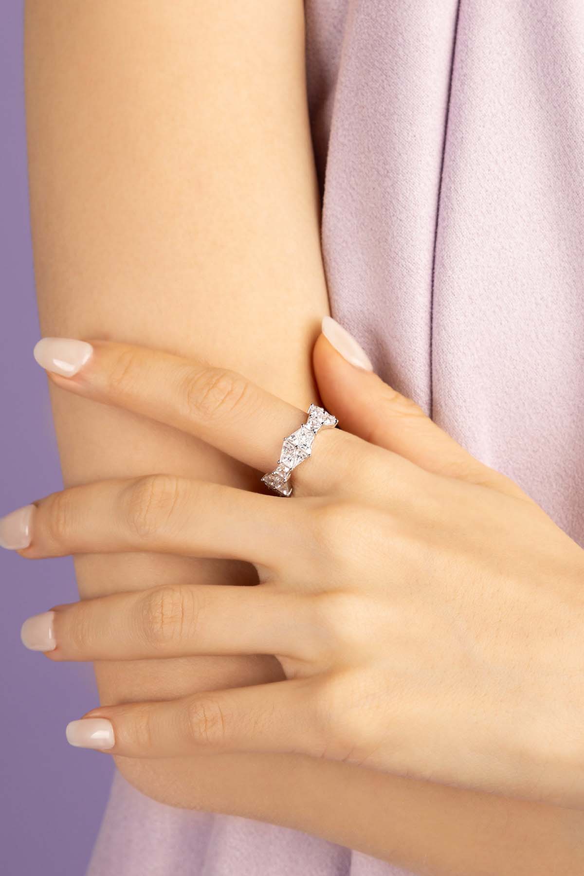 Close-up of a hand wearing a zirconia ring with a soft background
