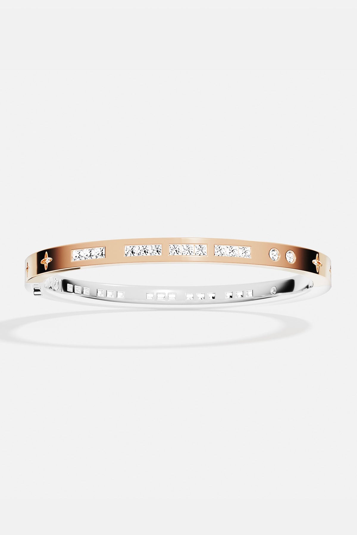 Bracelets APM Monaco two-tone gold and silver bangle with inlaid white stones.