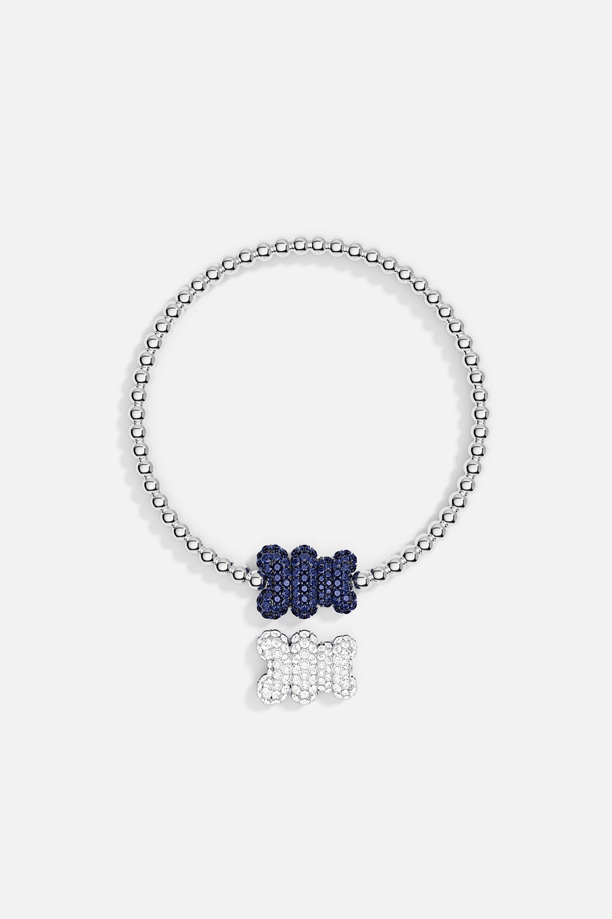 Bracelets APM Monaco: stretch beaded bracelet in silver-tone beads with two bone-shaped pendants, a blue pendant on the chain and a white pendant that dangles.