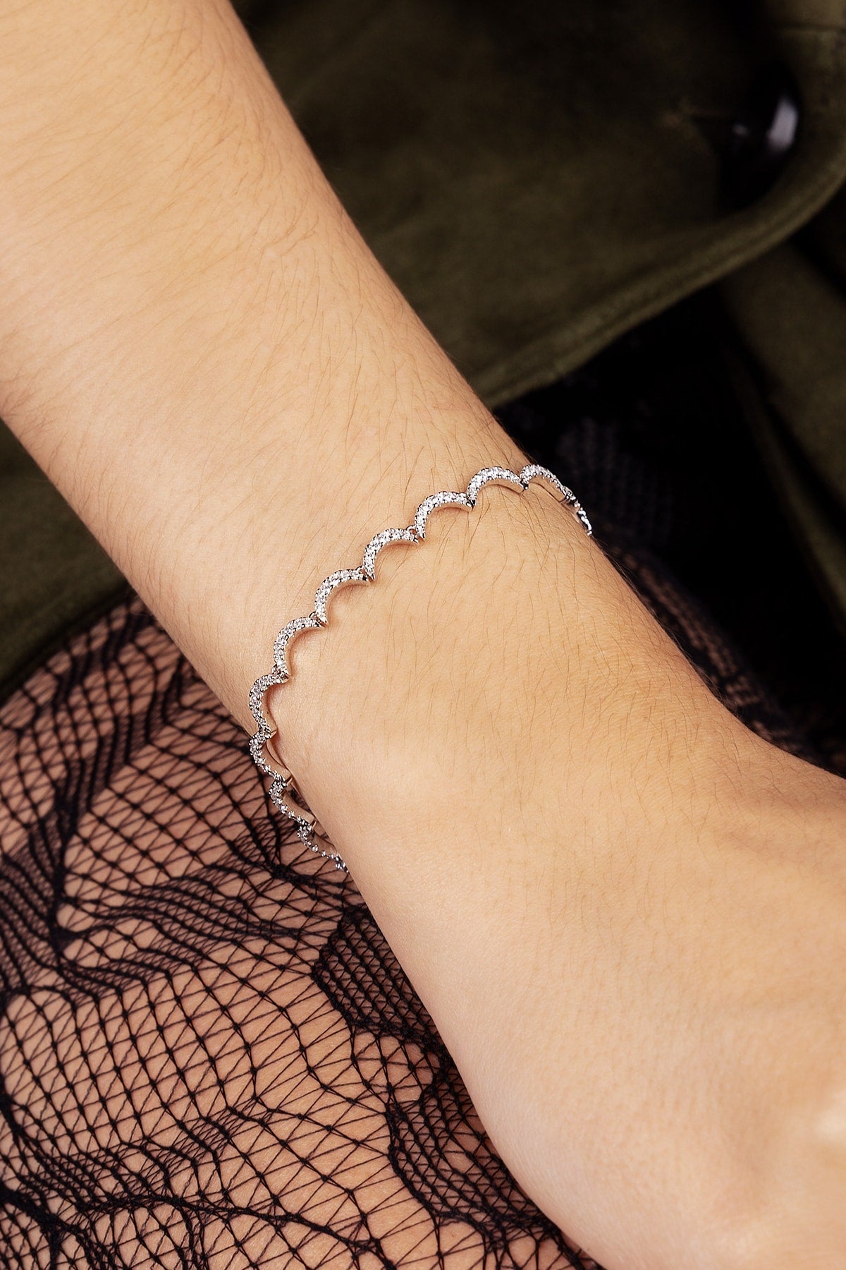 Close-up of a wrist wearing a bracelet with a blurred background