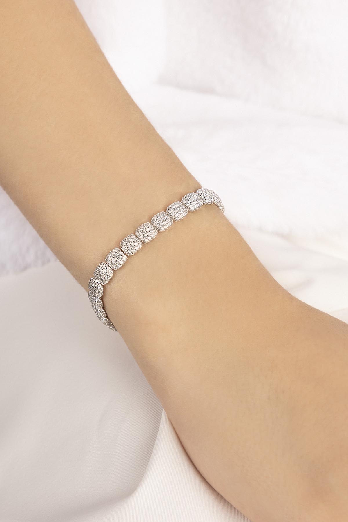 APM MONACO silver bracelet on a person's wrist against a white background