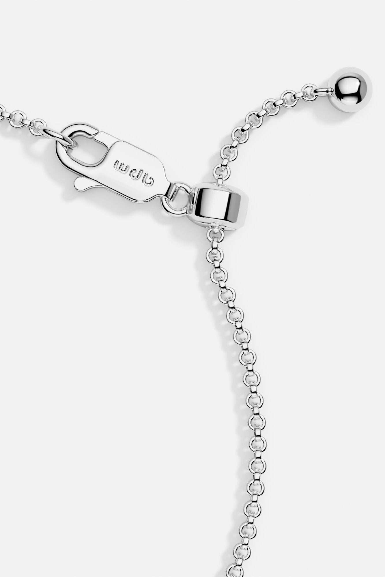 Close-up of heart-shaped silver bracelet with clasp from APM MONACO