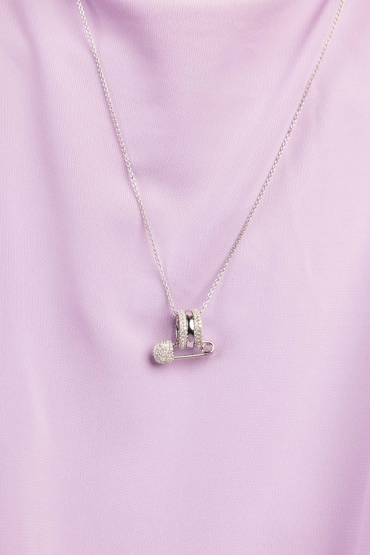 APM Monaco Safety Pin Adjustable Necklace worn on model with lilac background