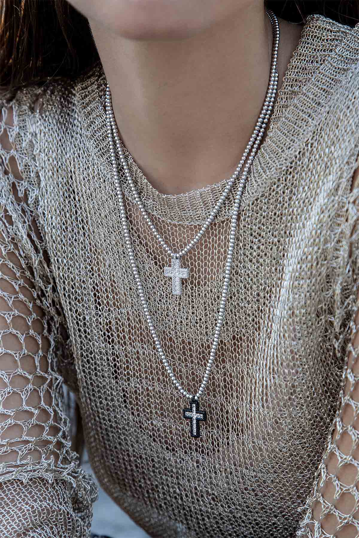 Necklaces APM Monaco: two adjustable pavé cross necklaces with bead accents in yellow-gold tone.