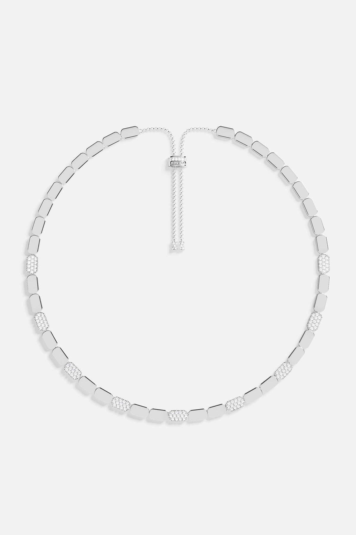Silver necklace on a light gray background