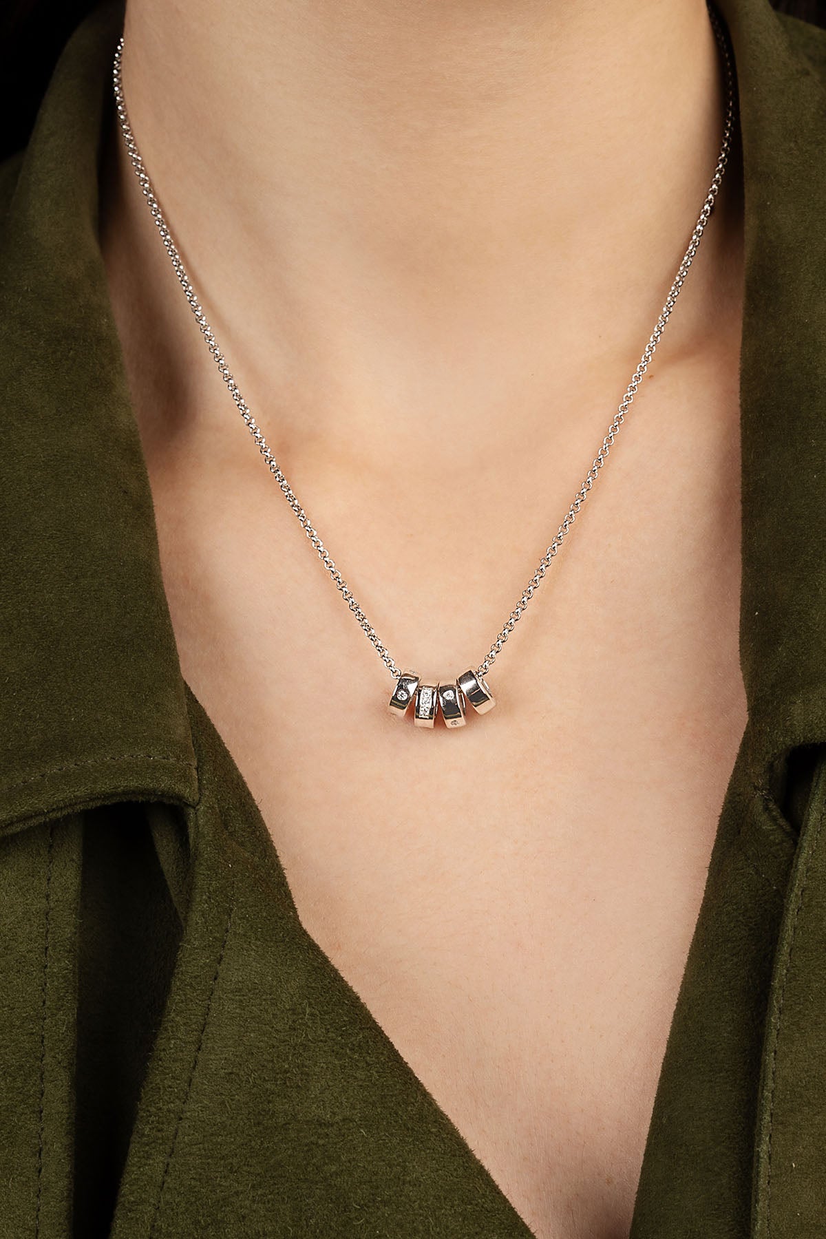 APM MONACO silver necklace worn on model.