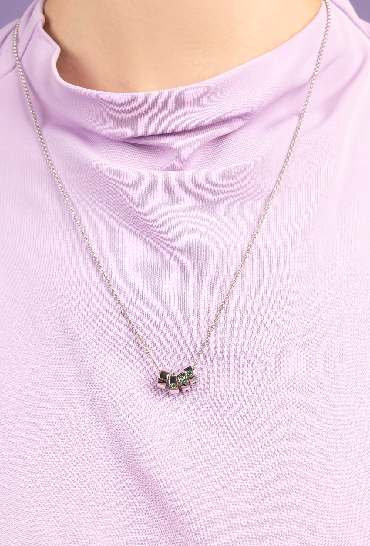 Necklace with a pendant on a person wearing a light purple shirt