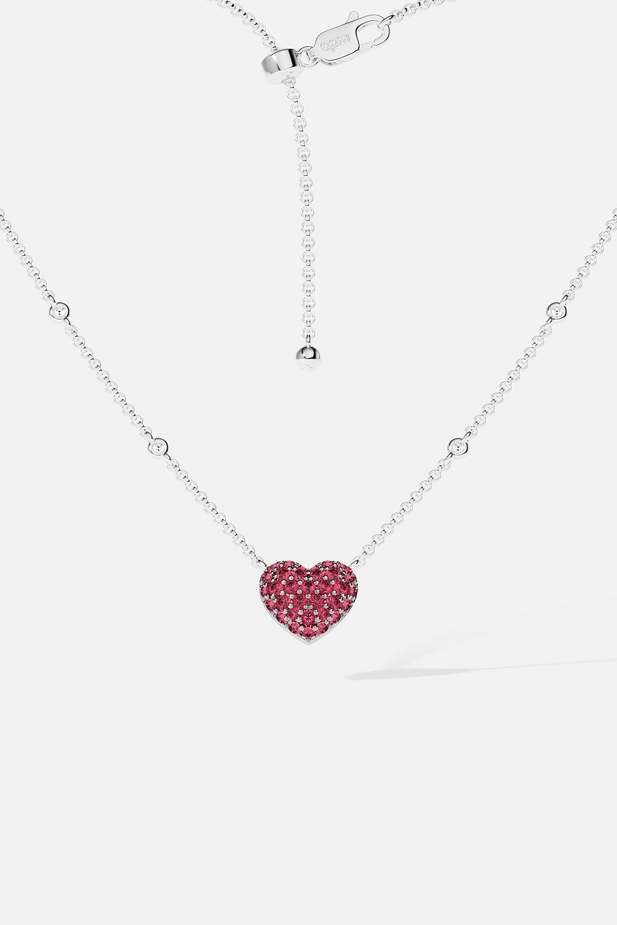 APM MONACO necklace with a heart-shaped fuchsia pendant on a white background