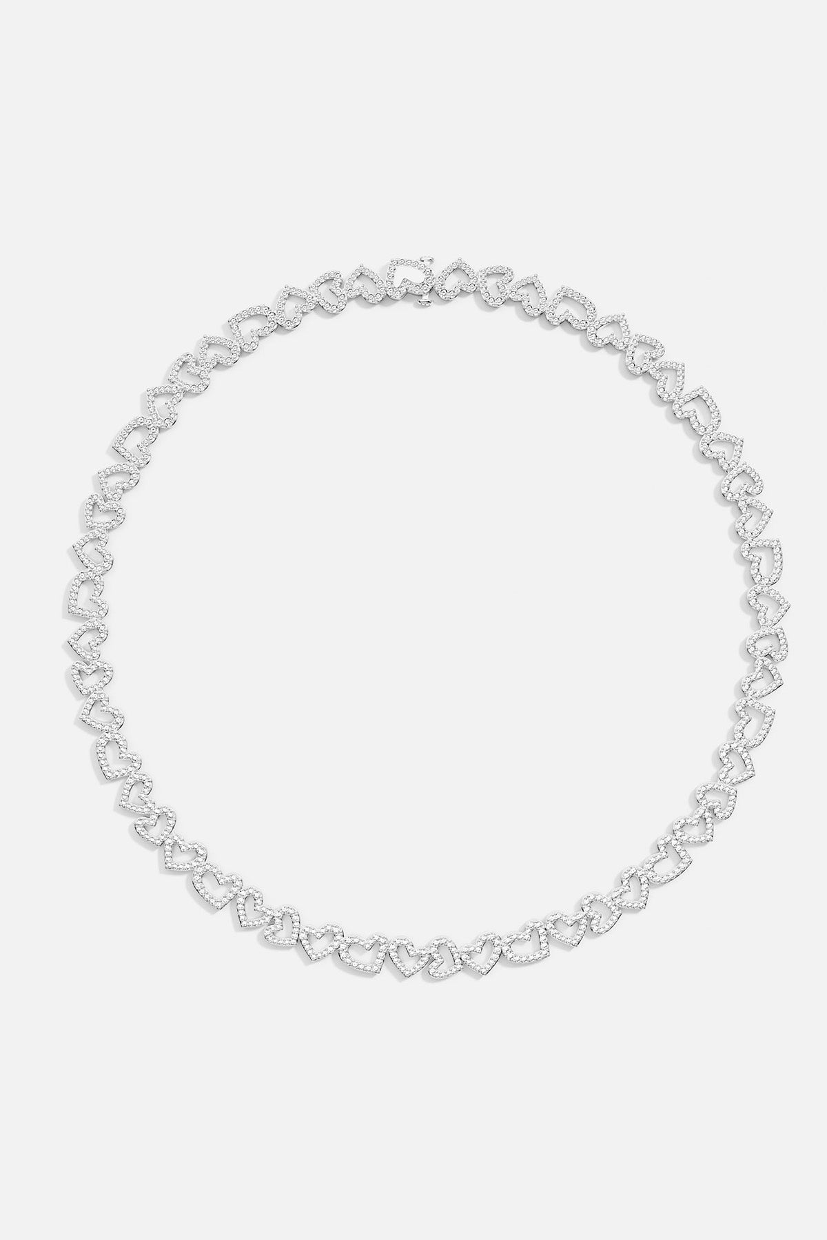 APM MONACO silver heart-shaped  necklace on a light gray background