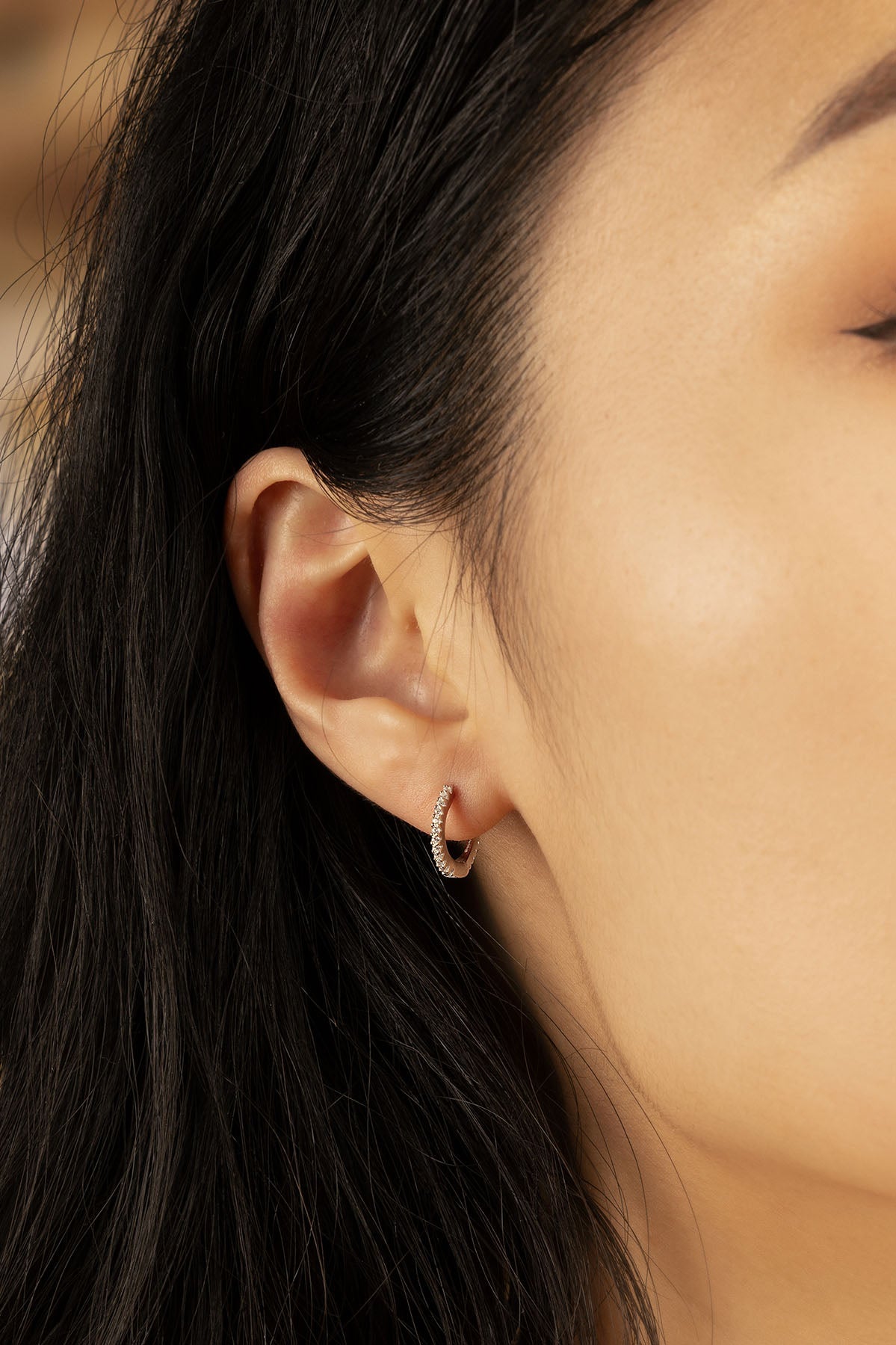 APM Monaco Small 8.5 mm Paved Hoop Earrings in Silver worn on hand