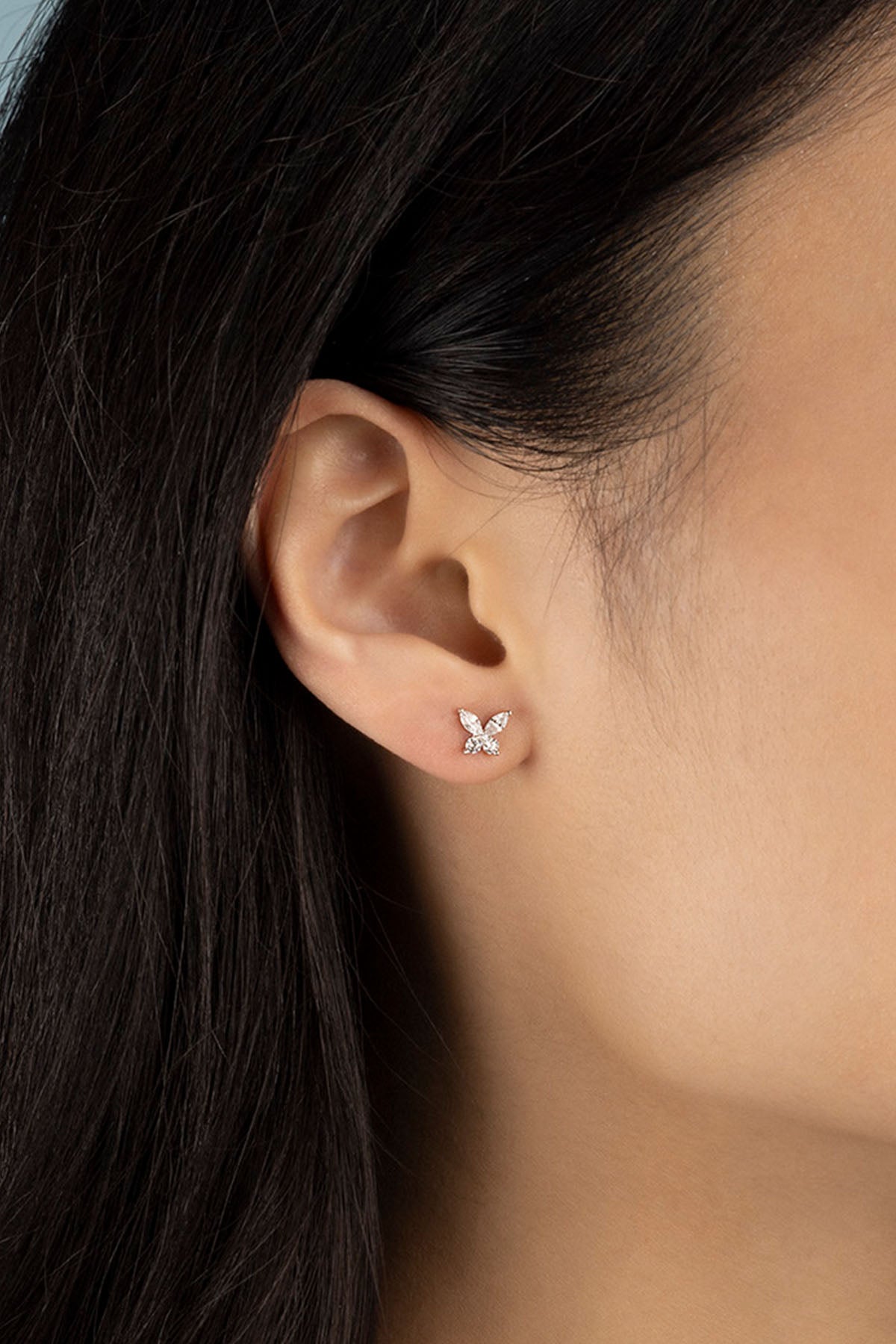 APM Monaco Butterfly Stud Earrings in Silver worn on ear