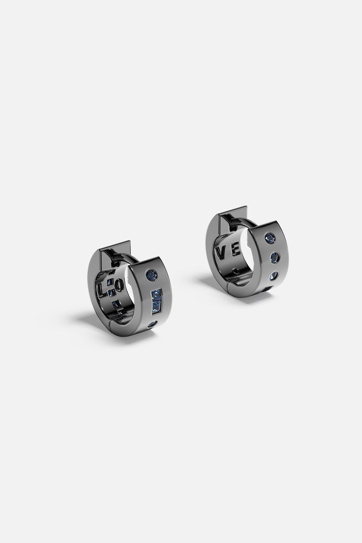 Earrings APM Monaco - pair of black huggie hoop earrings with white pavé diamonds.
