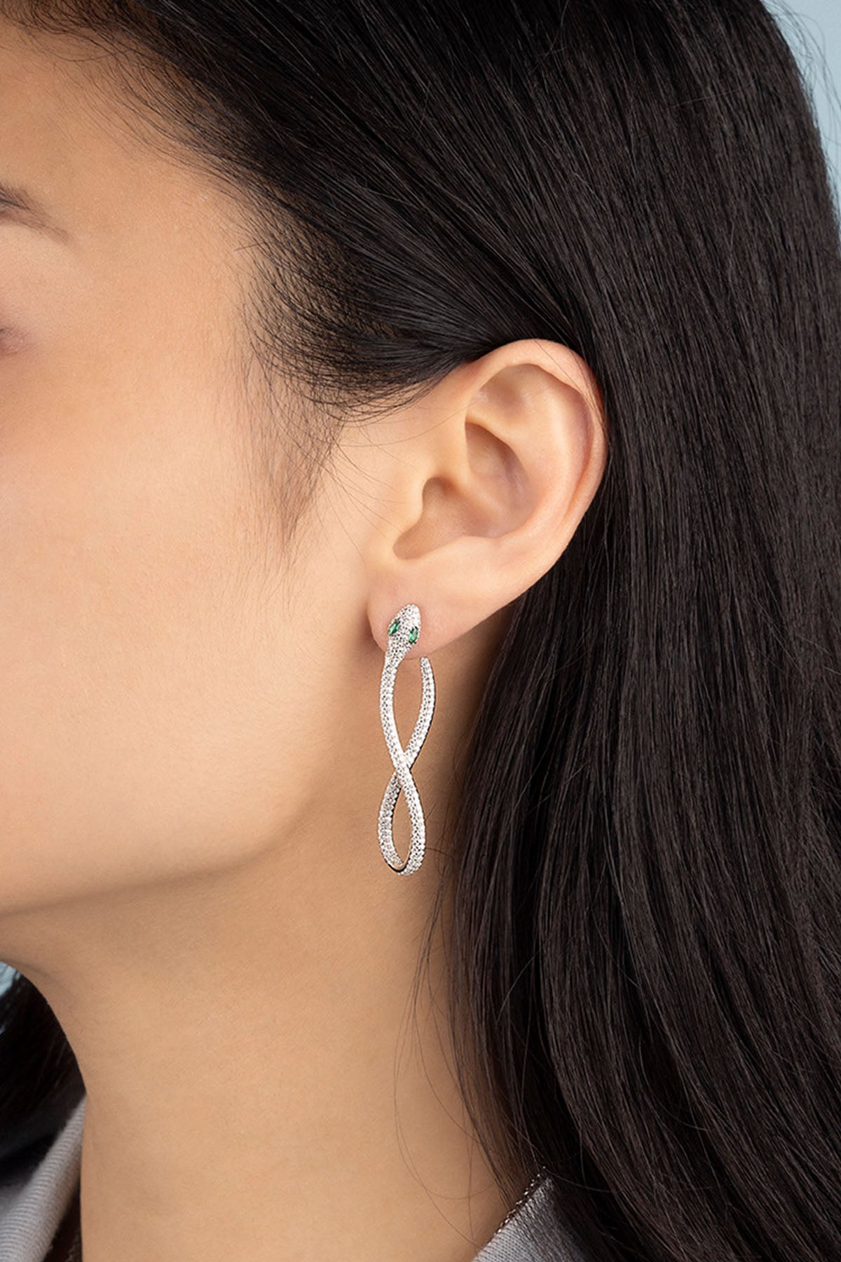 APM Monaco Pavé Kaa Earrings in silver worn on ear