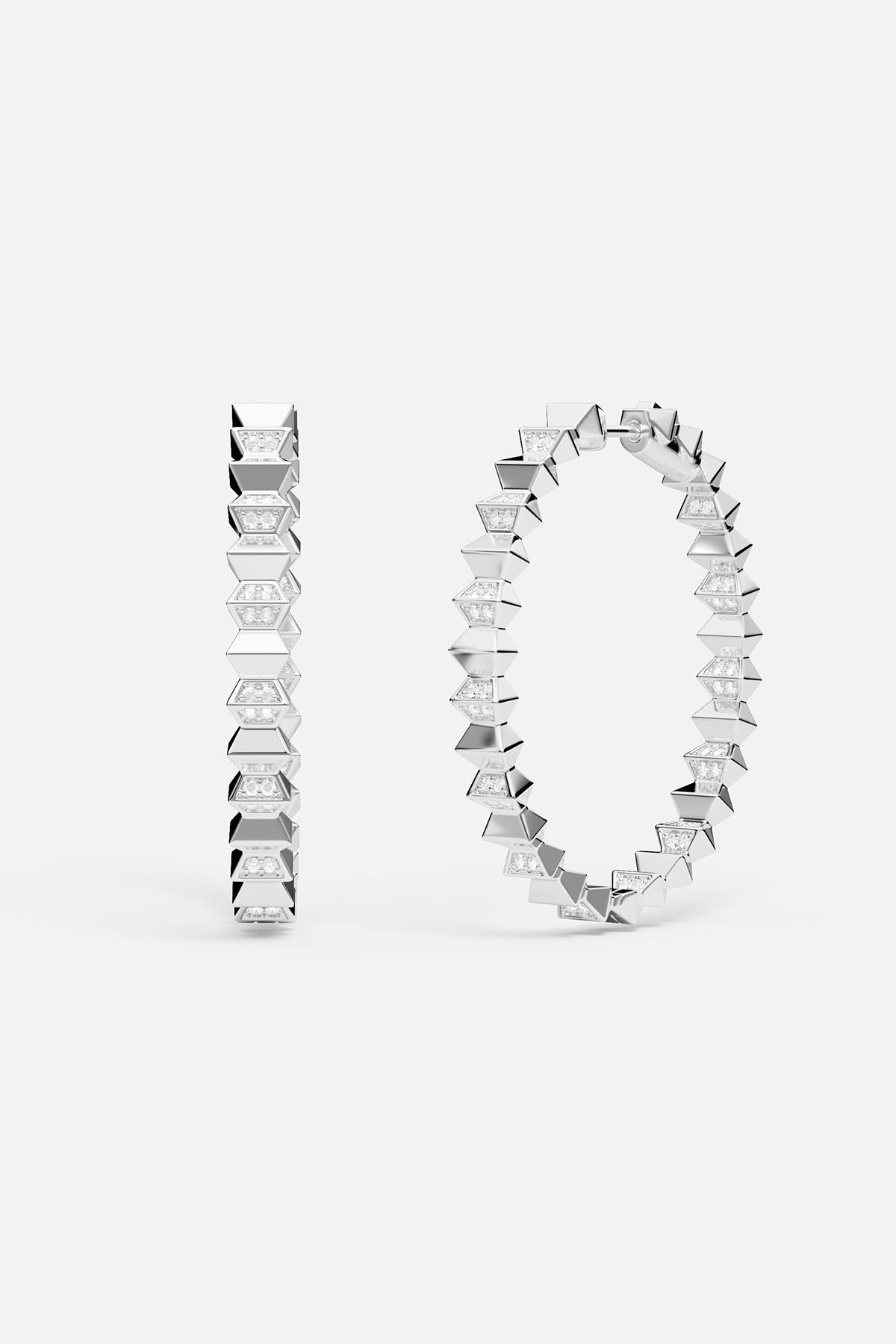 Silver hoop earrings with geometric design on a white background