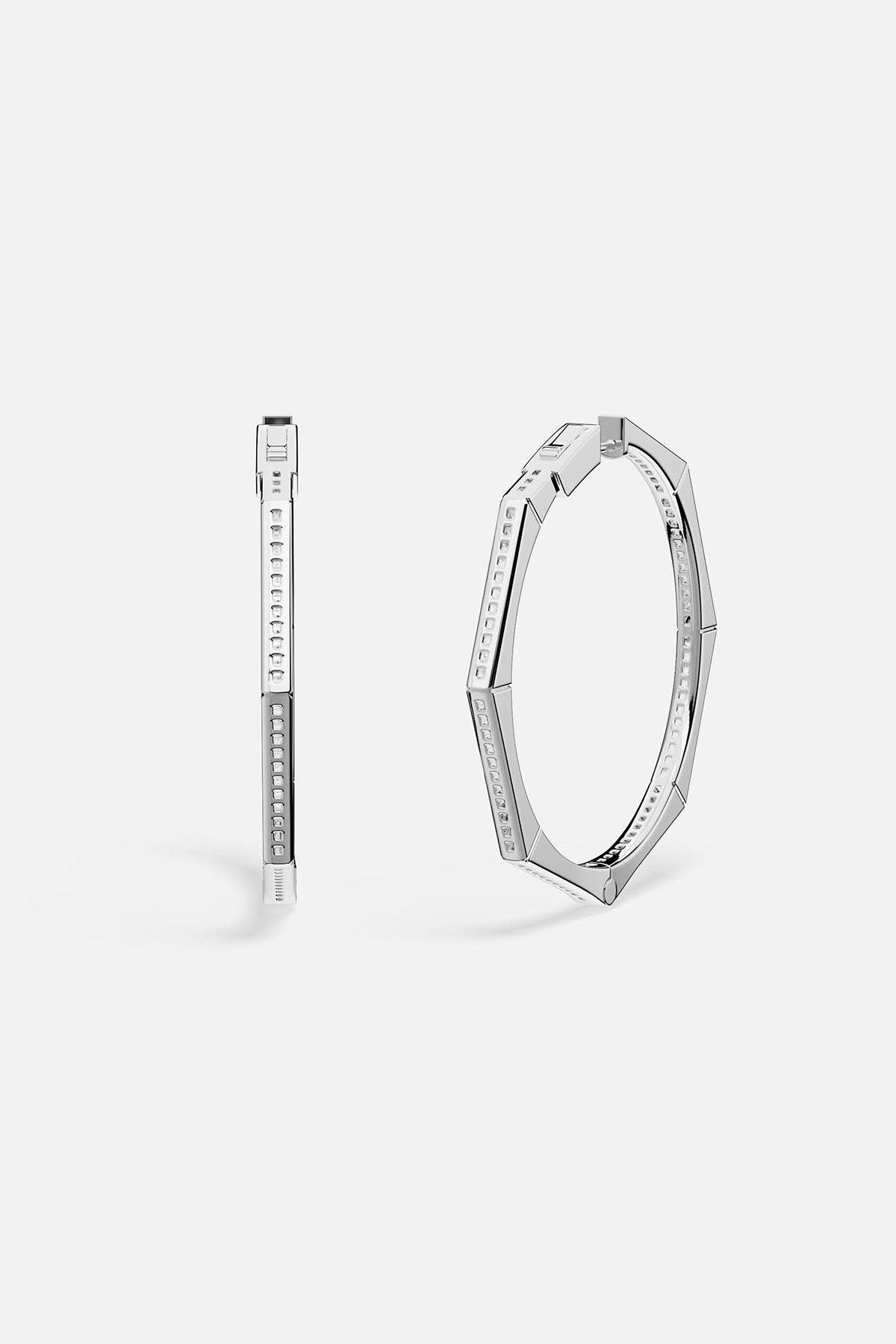 Pair of APM MONACO silver hoop earrings on a white background