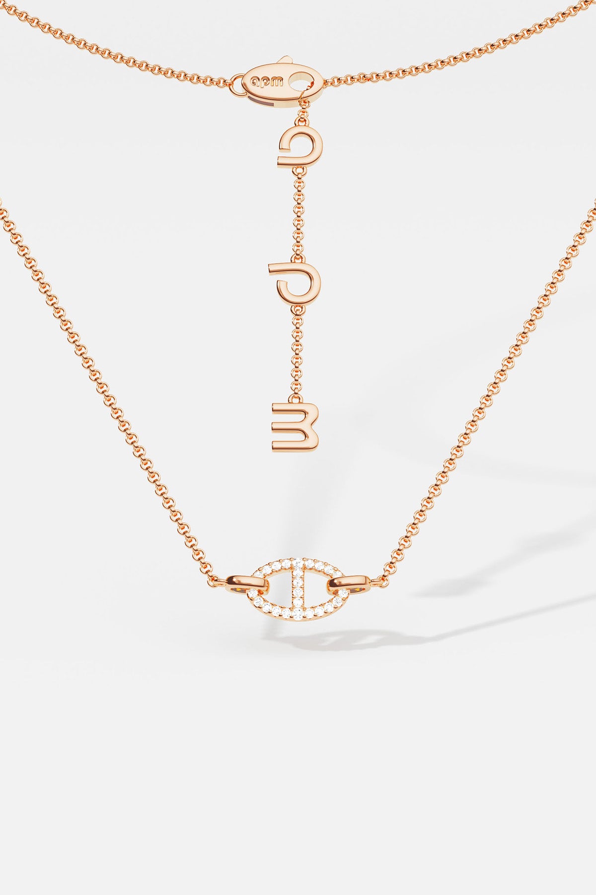 APM MONACO rose gold necklace with unique pendant on a white background
