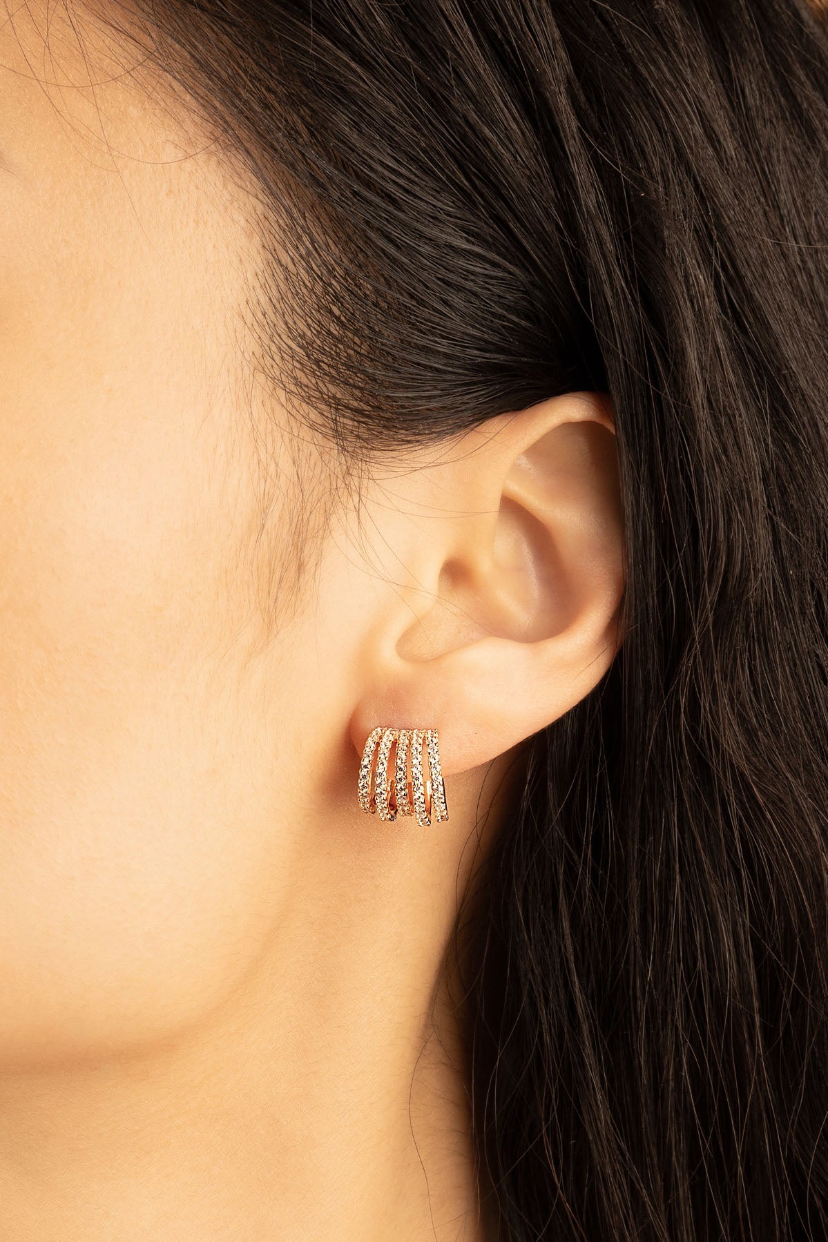 APM Monaco Five-hoop Earrings in Rose Gold worn on hand