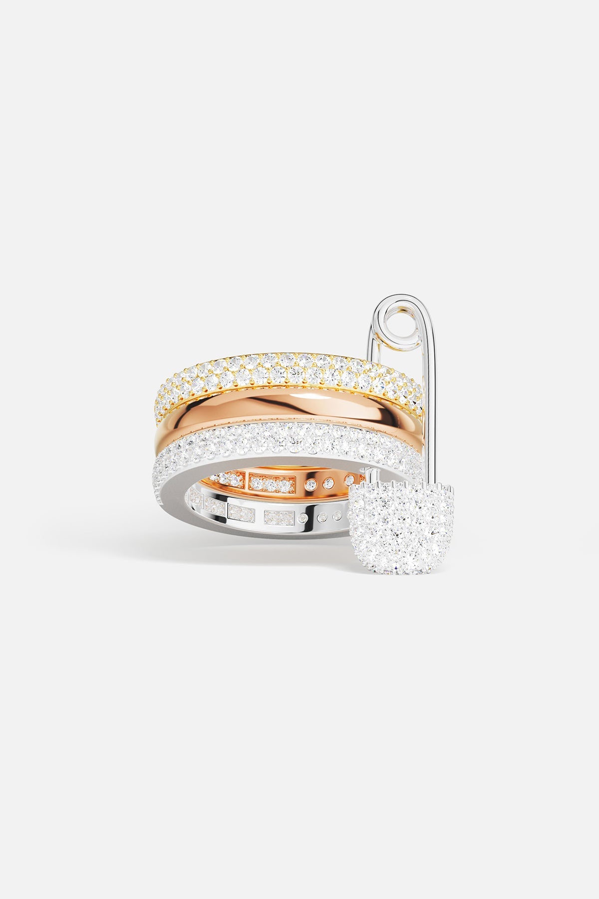 Two gold and silver tone rings with white stones on a white background