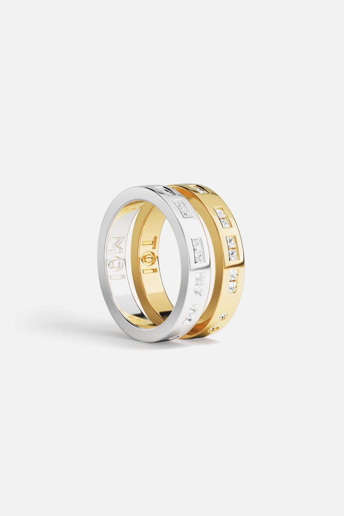 Rings APM Monaco: two stacked rings, yellow gold and white gold, white cubic zirconia, one with MOI engraving.