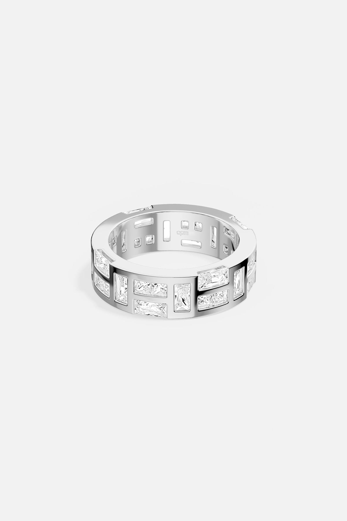 Silver-tone ring with embedded stones on a white background