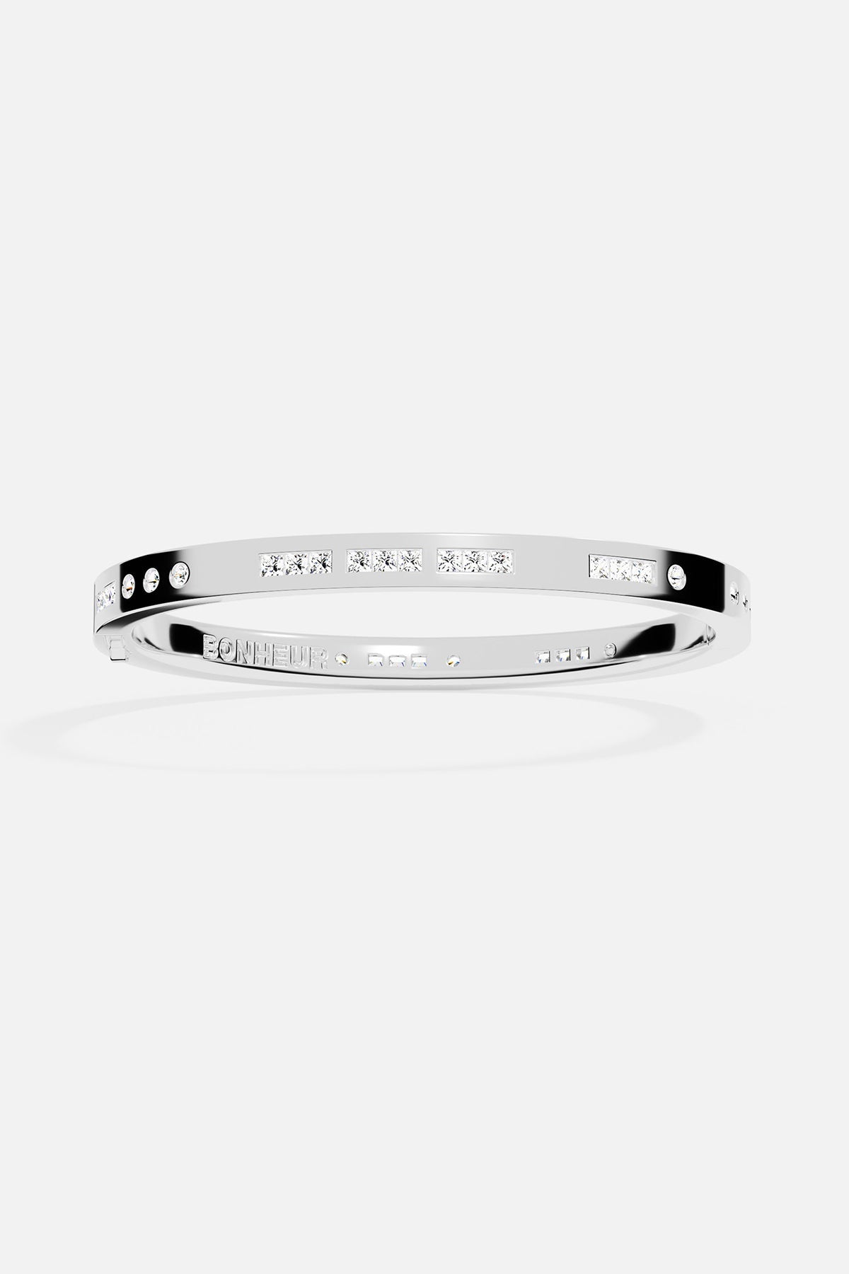 Silver bangle with engraved text on a white background