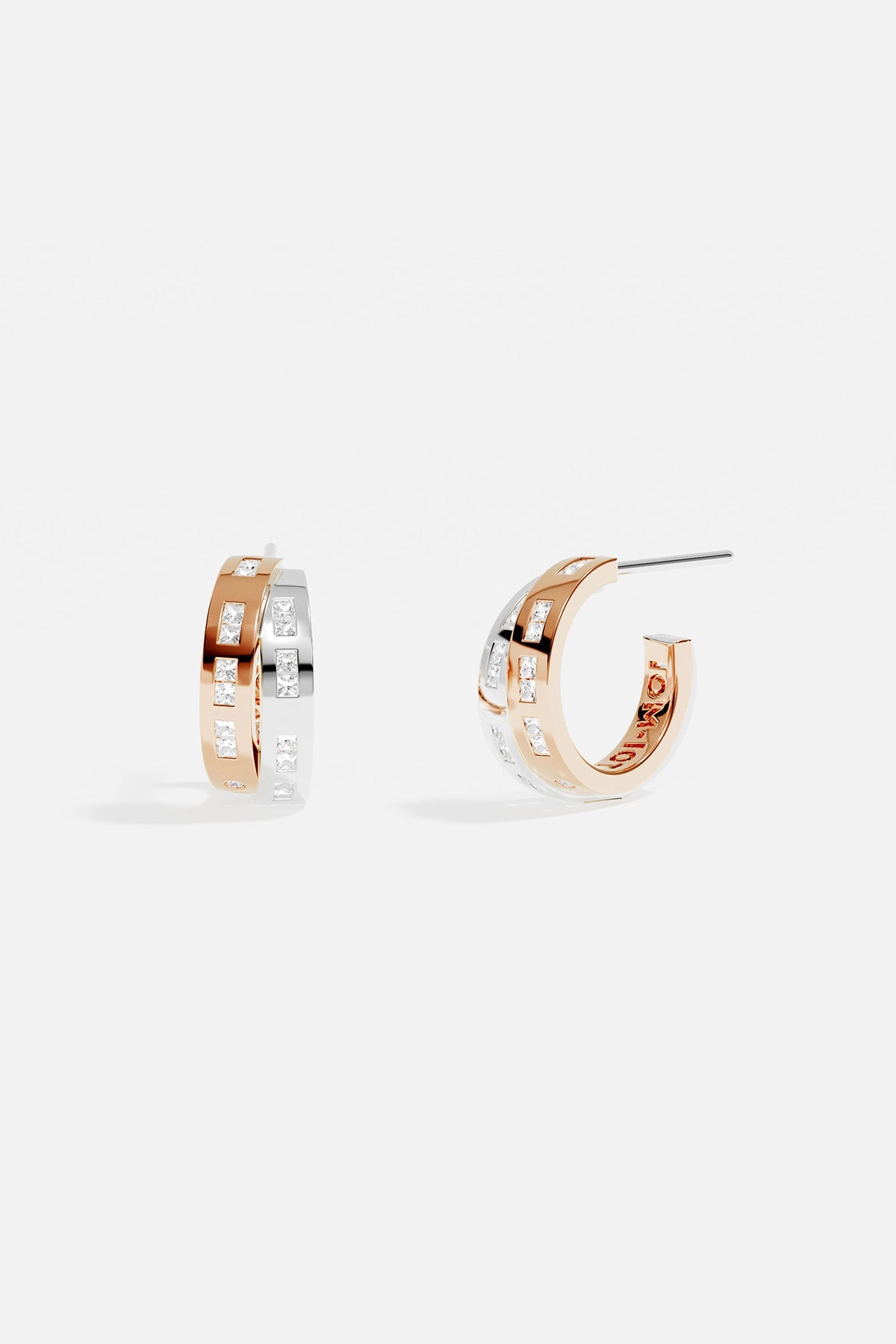 Earrings APM Monaco: two-tone rose gold and white gold intertwined design with morse-code motif, minimalist and delicate.