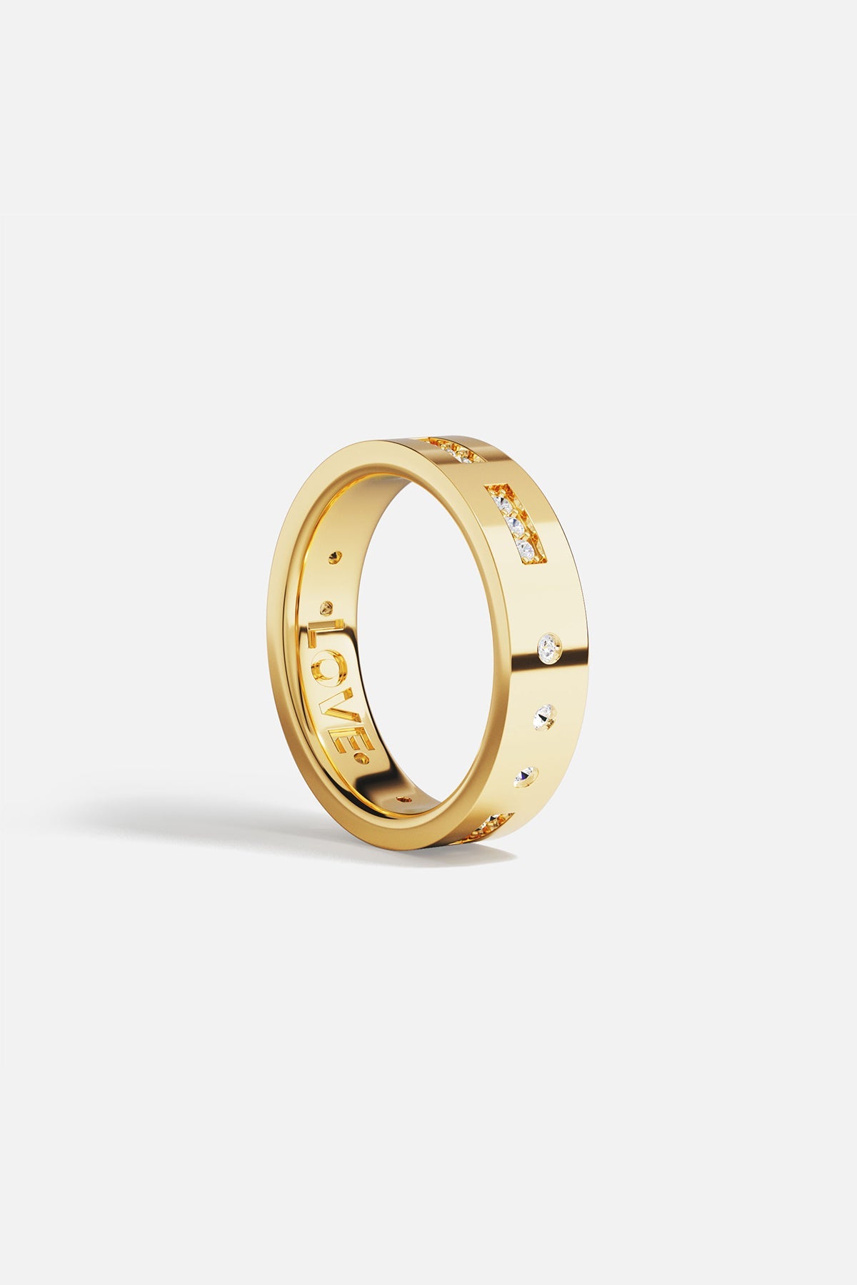 Rings APM Monaco. Yellow gold ring with white cubic zirconia on the outside and 'LOVE' engraved on the inside.