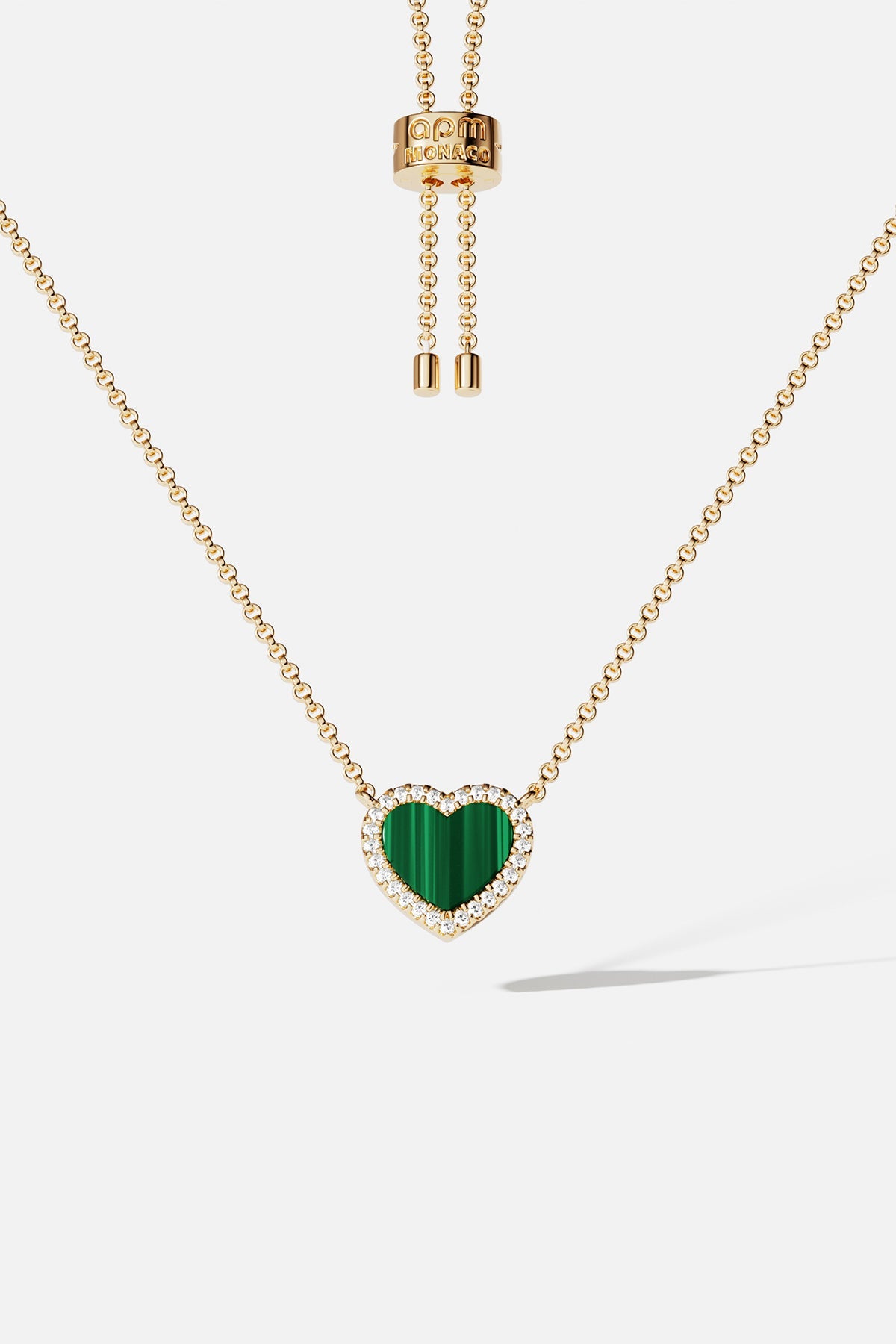 Necklaces APM Monaco. Yellow-gold chain with a green malachite heart pendant surrounded by white stones; adjustable length.