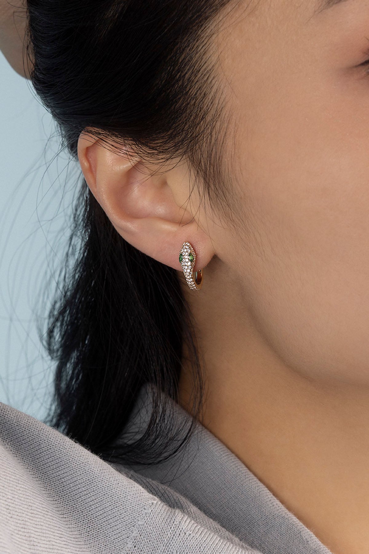 Close-up of an ear wearing earring with a blurred background
