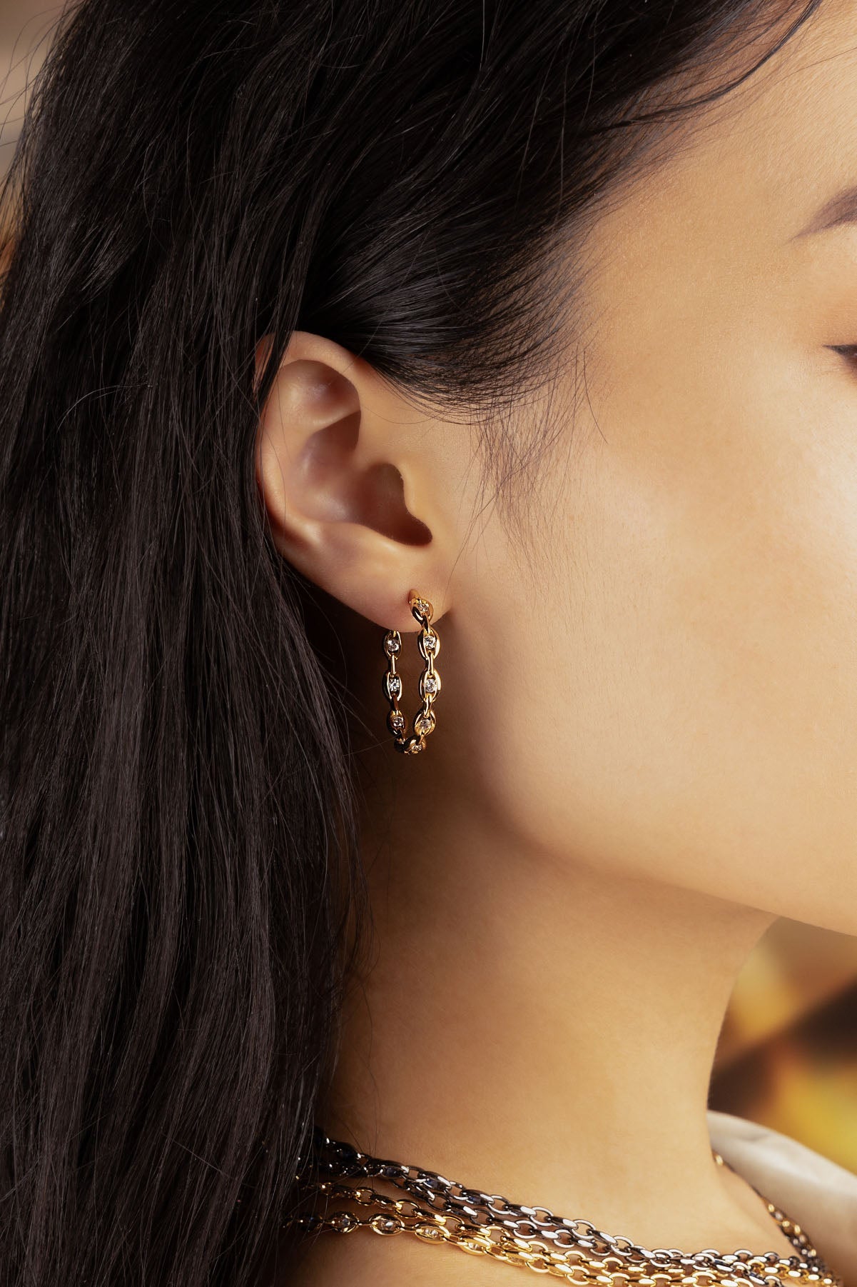 APM Monaco Pavé Chain Earrings in Yellow Gold worn on ear