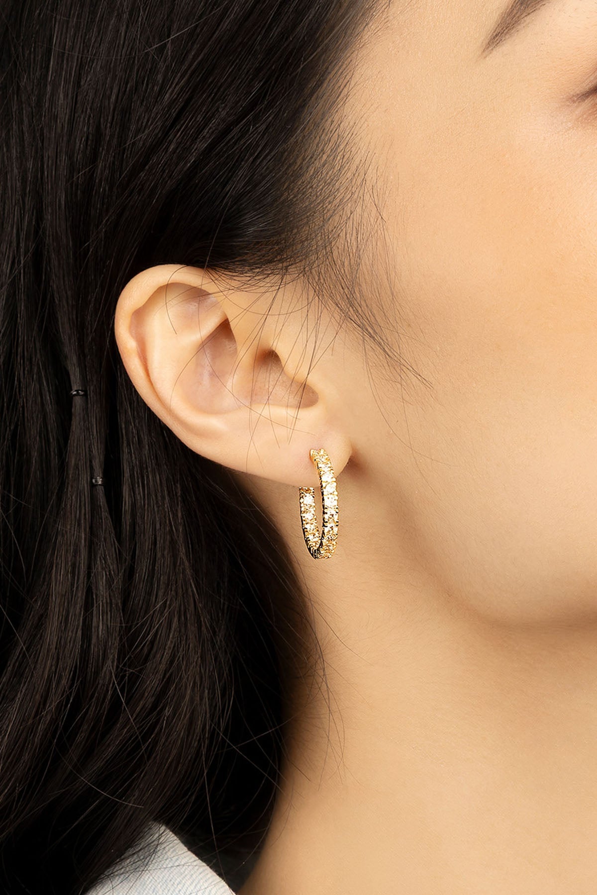 APM Monaco Pavé Hoop Earrings in Yellow Gold worn on ear